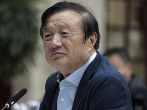In this Tuesday, Jan. 15, 2019, photo, Ren Zhengfei, founder and CEO of Huawei, listens to reporters questions during a round table meeting with the media in Shenzhen city, south China's Guangdong province.