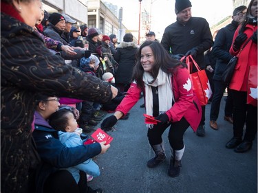 Veterans Affairs Minister Jody Wilson-Raybould, right, hands out lucky red envelopes while participating in the Chinese New Year Parade in Vancouver on Sunday, Feb. 10, 2019. More than 3,000 people participated in the parade according to organizers and more than 100,000 spectators were expected to line the parade route.