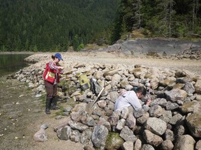 Ginevra Toniello and Dana Lepofsky examine a clam garden retaining wall on Quadra Island.