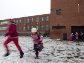 Children play in the playground at a school in Montreal on November 24, 2011.