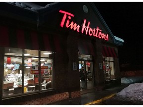 A customer walks out of a Tim Hortons restaurant in Newcastle, Ont. on Sunday Feb. 11, 2018.