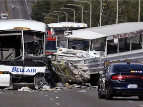 FILE - In this Sept. 24, 2015, file photo, a "Ride the Ducks" amphibious tour bus, right, and a charter bus remain at the scene of a multiple fatality collision on the Aurora Bridge in Seattle. A jury has awarded about $123 million to victims and families in a 2015 duck boat crash that killed five college students and wounded more than 60 others in Seattle. The Seattle Times reports Thursday, Feb. 7, 2019 that King County Superior Court jurors after a four-month civil trial found that Ride the Ducks International bore 67 percent of the responsibility for the crash, and tour vehicle operator Ride The Ducks of Seattle was 33 percent at fault.