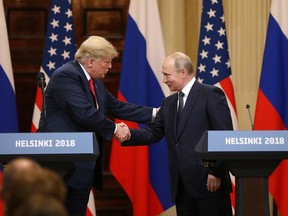 In this file photo U.S. President Donald Trump, left, shakes hands with Vladimir Putin, Russia's President, during a news conference in Helsinki, Finland, on Monday, July 16, 2018.