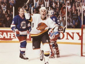 Vancouver Canucks winger Geoff Courtnall celebrates after scoring the winning goal in a regular season overtime game against the Winnipeg Jets in 1991.