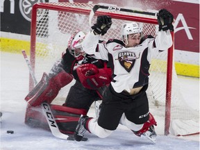Vancouver Giants captain Jared Dmytriw is knocked off his feet by the goalie stick of Prince George Cougars netminder Isaiah DiLaura in the first period Saturday at the Langley Events Centre.