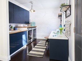 Navy blue cabinets from Ikea create beautiful storage, says interior designer Lisa Canning. Photo: Dan Tardiff for The Home Front: Transforming the neglected areas of your home by Rebecca Keillor  [PNG Merlin Archive]