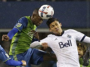 Seattle Sounders defender Kelvin Leerdam, left, heads the ball away from Vancouver Whitecaps forward Fredy Montero during the first half of the second leg of their 2017 MLS soccer Western Conference semifinal playoff game.