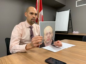 Kamloops RCMP Sgt. Nestor Baird displays a photo of murder suspect Hugh McInstosh. McIntosh and Gordon Braaten are wanted for murder and attempted murder in connection with the Feb. 15 shooting death in Brocklehurst of Jason Glover and the wounding of a woman.