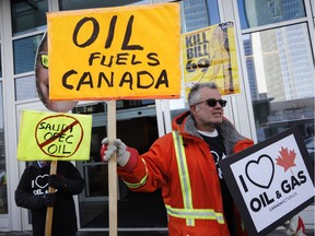 Oil and gas supporters picket outside the National Energy Board, during the release of the board's reconsideration report on marine shipping related to the Trans Mountain expansion project, in Calgary, Alta., Friday, Feb. 22, 2019.