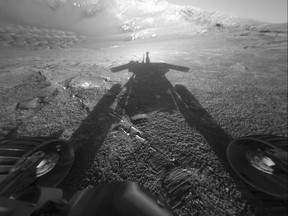 This July 26, 2004 photo made available by NASA shows the shadow of the Mars Exploration Rover Opportunity as it traveled farther into Endurance Crater in the Meridiani Planum region of Mars. (NASA/JPL-Caltech via AP)