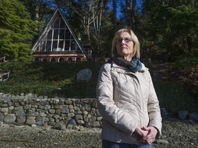 Nancy Strain of Coquitlam with the family cabin her father built in 1963 in Belcarra.