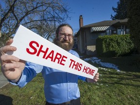 Realtor Noam Dolgin in front of a house listed for a 50 per-cent share sale in Vancouver.
