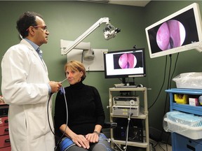 Dr. Amin Javer, with study subject Maggie Bernet, shows how photodynamic therapy — a blue-light treatment that sterilizes the nasal cavity as it kills bacterial and viruses — works as part of the broader nasal mucous transplant study at St. Paul’s Hospital.