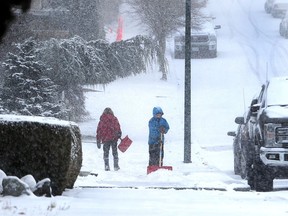 Residents get an early start on the snow shovelling with 10 cm expected in Vancouver, BC., February 10, 2019.