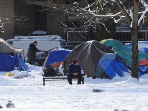 Snow covers Oppenheimer Park as homeless people sleep in tents.