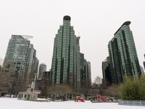 Giant condo buildings in Coal Harbour tower over a park in Vancouver.