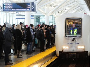 A snowfall warning remains in effect for much of the B.C. south coast region on Tuesday, prompting a second day of transit crowds. Morning commuters wait for a skytrain at Broadway station in Vancouver, BC., February 12, 2019. All trains are being driven by an operator following yesterday's delays.