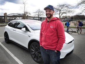 Tesla owner Zach Taylor, who has noticed a benefit in driving an electric vehicle as gas prices continue to increase with his car in Vancouver, BC., April 3, 2018.