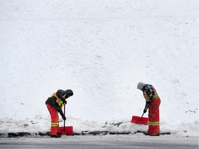 Not into snow? Don't worry – Burnaby's got a plan in place for dealing with it. Workers are pictured shovelling snow at Burnaby Mountain in this December 2017 file photo.