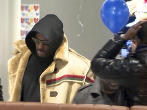 In this image made from a video, R. Kelly stops at a McDonald's restaurant in Chicago Monday, Feb. 25, 2019. (WFLD via AP)