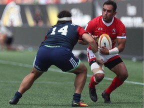 Canada's Phil Mack, right, avoids a tackle from Mike Te'o of USA during the 2019 Rugby World Cup Qualifier in Hamilton, Ont., on June 24, 2017. Canada captain Phil Mack's welcome will likely be warm and short Sunday when the Toronto Arrows visit his Seattle Seawolves in Major League Rugby play. Introductions won't be needed. Thirteen of the Arrows' starting 15 are Canadian and nine members of the matchday 23 are Canadian internationals.