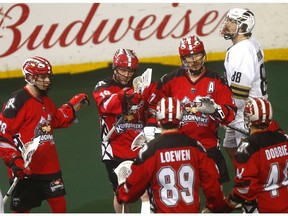 Calgary Roughnecks forward Rhys Duch celebrates his goal on battles Vancouver Warriors goalie Eric Penney in NLL action at the Scotiabank Saddledome in Calgary on Saturday.