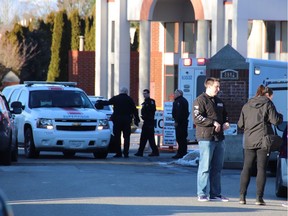 First responders stand outside Immaculate Conception elementary school in Delta, B.C. on Wednesday Feb. 20, 2019. Police say an off-duty officer and a woman were stabbed outside a private elementary school.