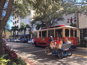 Trams and pedicabs, seen here on Clematis Street, are just two of the ways to see the sights.