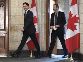 Prime Minister Justin Trudeau leaves his office with his principal secretary Gerald Butts to attend a cabinet meeting on Parliament Hill in Ottawa on Tuesday, April 10, 2018.