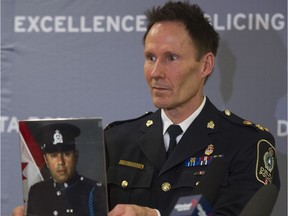 Delta Police Chief Neil Dubord holds up a photo of acting Sgt. John Jasmins,  February 21. 2019.   Jasmins intervened in a domestic dispute by tackling a man who is also accused of stabbing his wife.