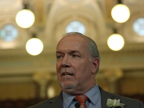 Premier John Horgan answers questions from the media during a press conference following the speech from the throne in the legislative assembly in Victoria, B.C., on Tuesday, February 12, 2019.