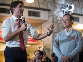 Prime Minister Justin Trudeau addresses the audience, pumping for federal Liberal candidate Richard T. Lee (right) on Sunday in the Burnaby South byelection campaign. Voters go to the polls in that riding and two other vacant ridings on Feb. 25.