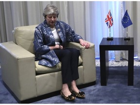 British Prime Minister Theresa May takes her seat as she prepares to meet with European Council President Donald Tusk for a bilateral meeting on the sidelines of a summit of EU and Arab leaders at the Sharm El Sheikh convention center in Sharm El Sheikh, Egypt, Sunday, Feb. 24, 2019. British Prime Minister Theresa May is set to hold Brexit talks with European Council President Donald Tusk ahead of a potentially pivotal week for her plans to lead her country out of the European Union.