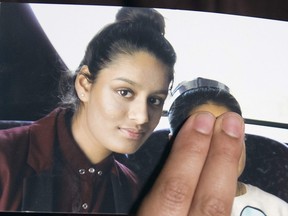 In this file photo taken on February 22, 2015 Renu Begum, eldest sister of missing British girl Shamima Begum, holds a picture of her sister while being interviewed by the media in central London.