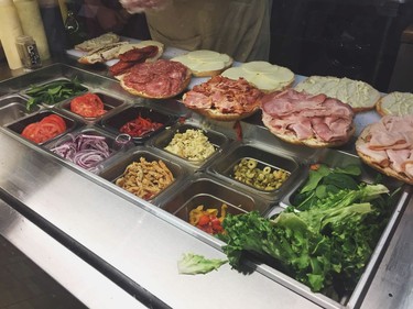 Full Focaccia sandwiches are prepared for a to-go order at La Grotta del Formaggio on Commercial Drive.