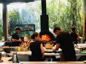 Cooking in the open kitchen at Arca restaurant in Tulum, Mexico.