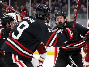 Austin Plevy #14 of the Northeastern Huskies celebrates with Tyler Madden #9 after scoring a goal against the Boston College Eagles during the 2018 Beanpot Tournament Championship game at TD Garden on February 11, 2019 in Boston, Massachusetts.
