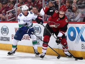 Arizona's Jakob Chychrun beats Loui Eriksson of Vancouver to the puck Thursday as the Coyotes crushed the Canucks 5-2 in NHL action at Gila River Arena in Glendale, Ariz.