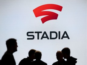 Attendees stand near the Stadia logo during the GDC Game Developers Conference on March 19, 2019 in San Francisco, California. Google announced Stadia, a new streaming service that allows players to play games online without consoles or computers.