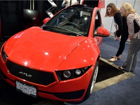 Showgoers check out an Electra Meccanica Solo at CES 2018 earlier this week in Las Vegas.