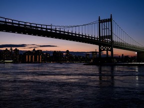 The sun sets behind the skyline of uptown Manhattan next to the Robert F. Kennedy Bridge which spans over the East River on March 4, 2019, in New York City.