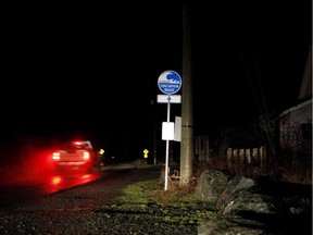 A truck drives by an evacuation route sign in Jordan River, B.C., on Tuesday, January 23, 2018. A researcher says people living in more than 90 per cent of households in Port Alberni, B.C., left for higher ground in the dead of night during a tsunami warning on Jan. 23, 2018. And although there was no tsunami, lessons can still be learned from the response.