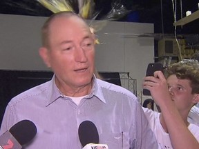 In this image made from video, a teenager breaks an egg on the head of Senator Fraser Anning while he holds a press conference, Saturday, March 16, 2019, in Melbourne, New Zealand. Following the mass shootings on Friday, Anning came under sharp criticism over tweets including one that said: "Does anyone still dispute the link between Muslim immigration and violence?" (AP Photo)