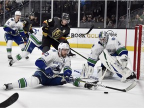Vancouver Canucks defenseman Alexander Edler (23) and goaltender Jacob Markstrom (25) defend against the Vegas Golden Knights during the second period of an NHL hockey game Sunday, March 3, 2019, in Las Vegas.