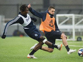 Georges Mukumbilwa, left, takes on Brett Levis during a practice session in January at the Vancouver Whitecaps training centre.