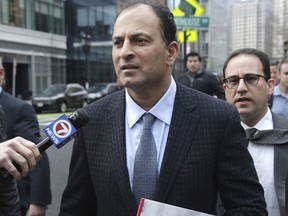 David Sidoo leaves following his federal court hearing in Friday, March 15, 2019, in Boston. Sidoo pleaded not guilty to charges as part of a wide-ranging college admissions bribery scandal.