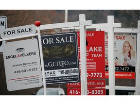 Real estate for sale signs are shown in Oakville, Ont. on December 1, 2018. The Canadian Real Estate Association says home sales in February fell compared with a year ago as the average selling price also moved lower. The association says sales last month were down 4.4 per cent compared with Feburary of 2018.