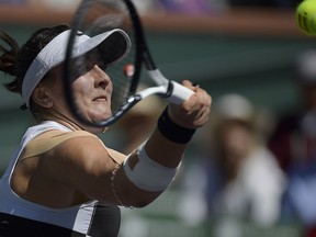 Bianca Andreescu, of Canada, returns a shot to Angelique Kerber, of Germany, during the women's final at the BNP Paribas Open tennis tournament Sunday, March 17, 2019, in Indian Wells, Calif. Bianca Andreescu's surprise run to the final of the BNP Paribas Open was a promotional gift from the heavens for DAZN Canada.