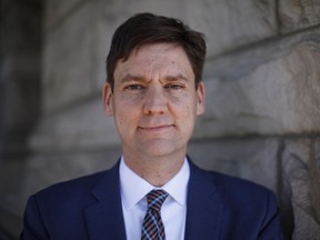 Attorney General David Eby is photographed on the steps of the Legislature library.