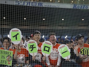 Fans of Seattle Mariners right fielder Ichiro Suzuki cheer with banners reading "Ichiro" at the spectators' stand prior to Game 1 of a Major League opening series baseball game between the Mariners and the Oakland Athletics at Tokyo Dome in Tokyo, Wednesday, March 20, 2019.